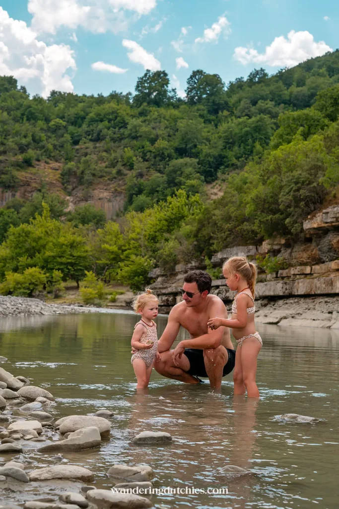 Vader en kinderen spelen samen in de rivier bij Osumi Canyon.