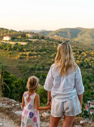 Moeder en dochter kijken uit over de heuvels van Albanië tijdens hun rondreis met kinderen – kosten rondreis Albanië in beeld gebracht