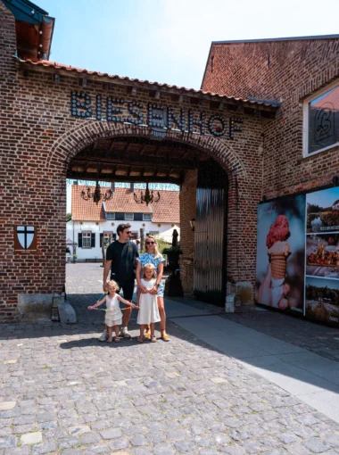 Gezin bij de ingang van restaurant Biesenhof in Geleen, onder sfeervolle poort met lichtletters in zomerse setting