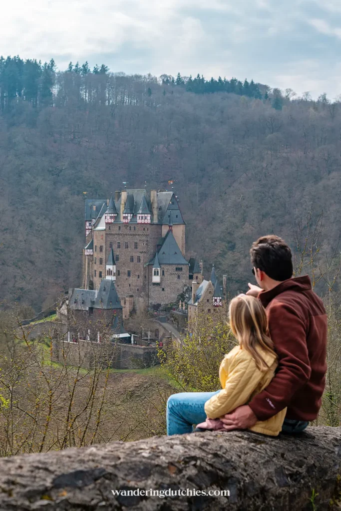 Father and daughter looking out over Burg Eltz in Germany.