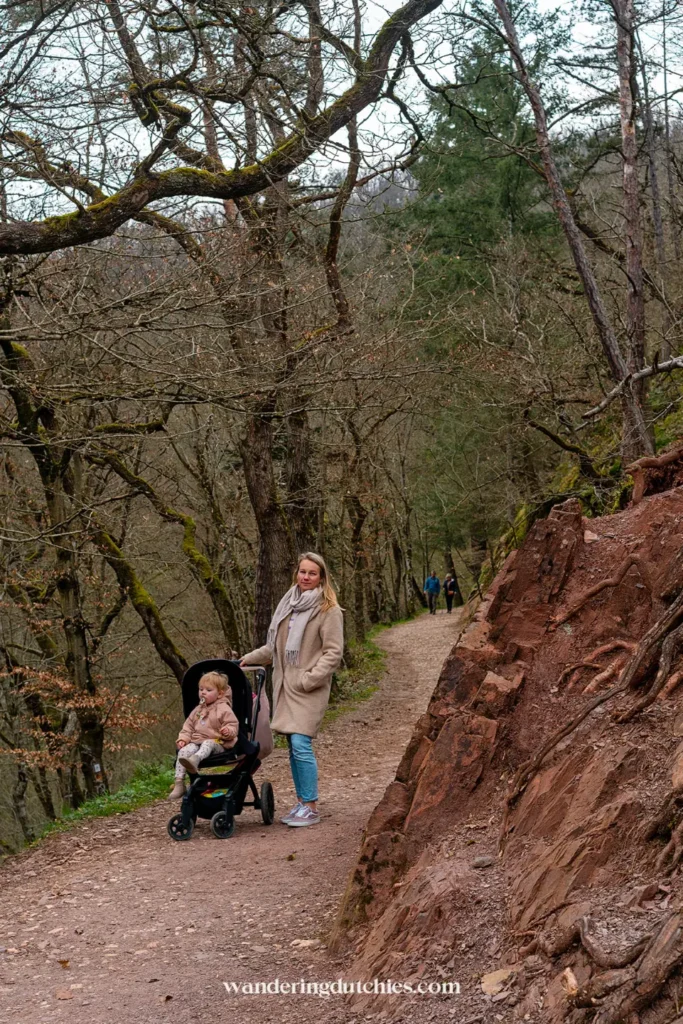 Walk through the forest toward Burg Eltz with a child in a stroller.