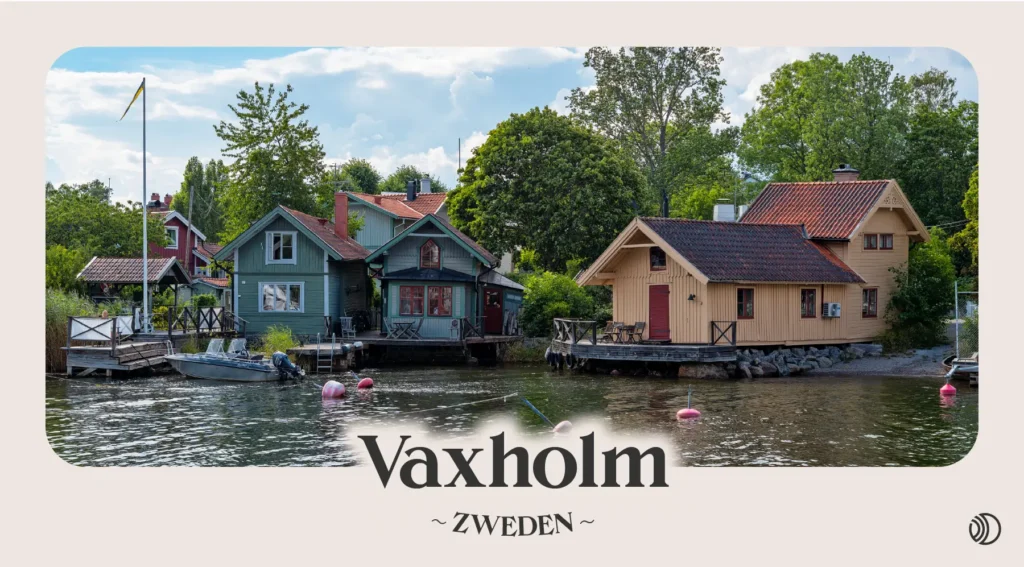 Kleurrijke houten huisjes aan het water in Vaxholm met bootjes en boeien