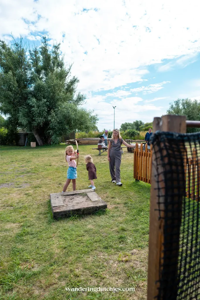 Kinderen spelen met boog en pijl in het Foteviken Viking Museum in Zuid-Zweden