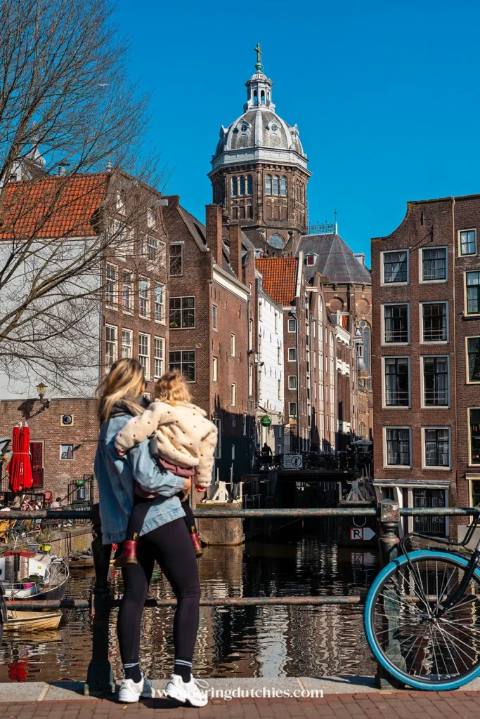 Woman overlooking a canal in Amsterdam's Red Light District