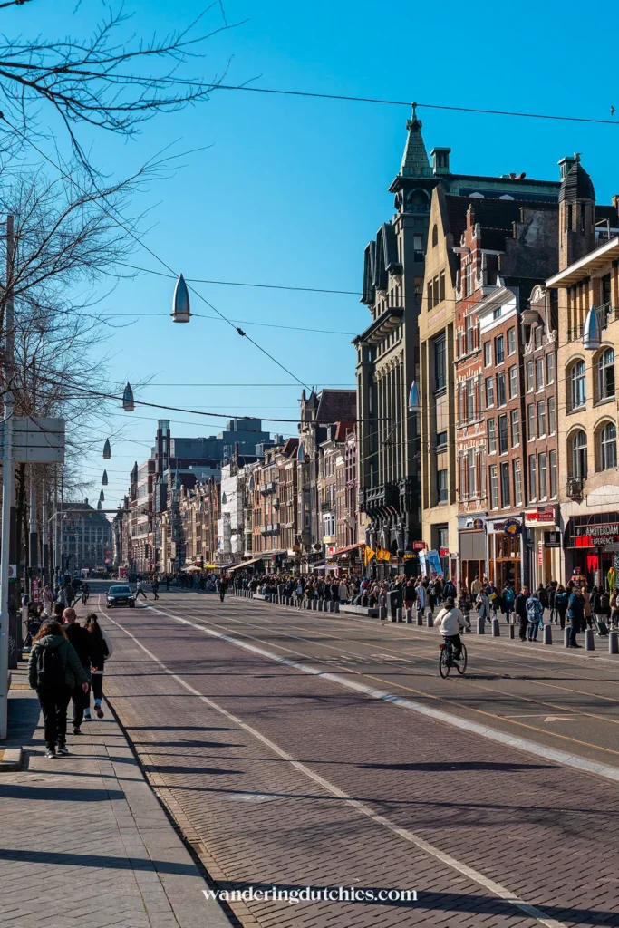 Damrak in Amsterdam with trams, cyclists and pedestrians