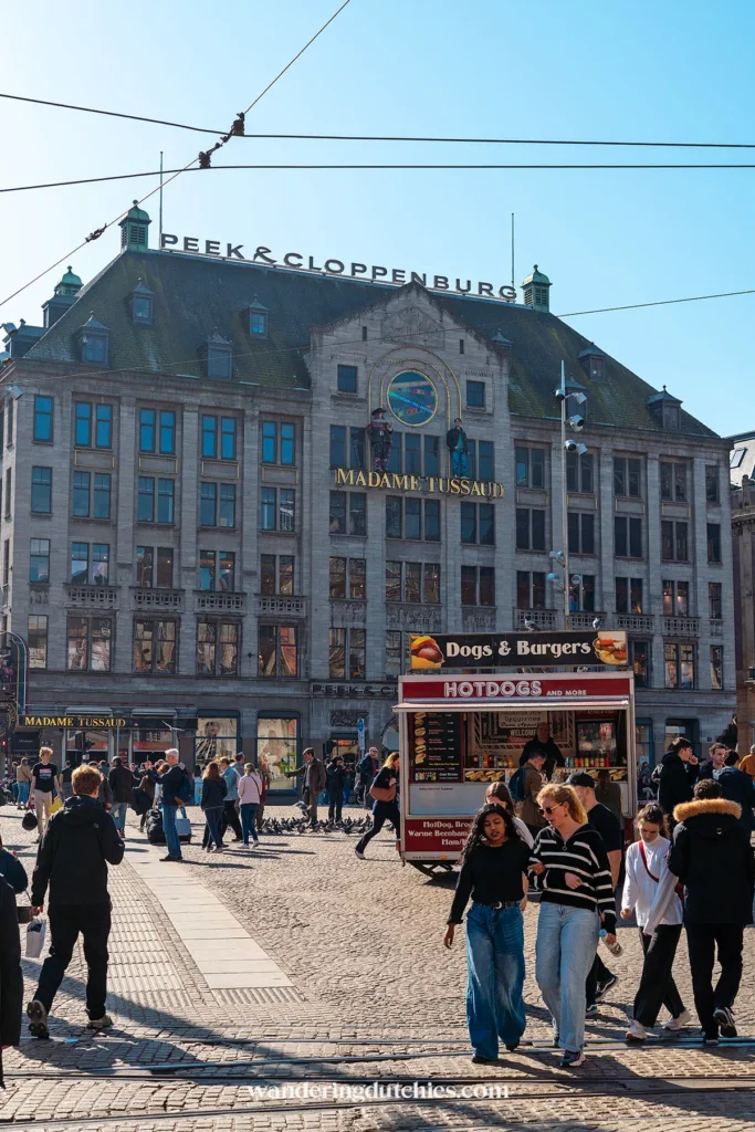 Crowds on Dam Square in Amsterdam with Madame Tussauds in the background