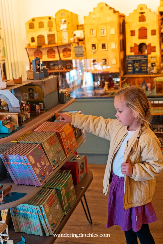 Child exploring miniature houses at The Mouse Mansion in Amsterdam