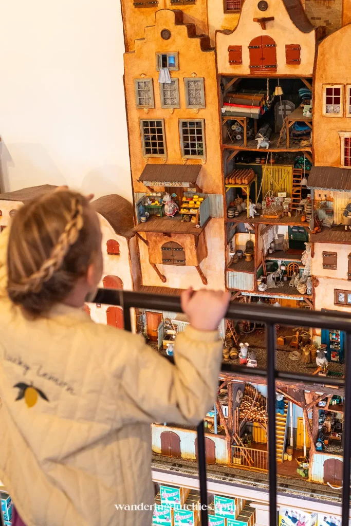 Child looking out over the miniature world of The Mouse Mansion in Amsterdam