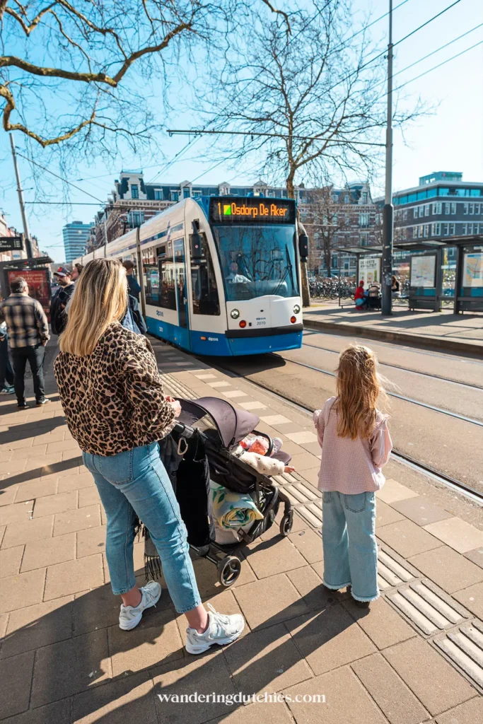 Family waiting for a tram in Amsterdam