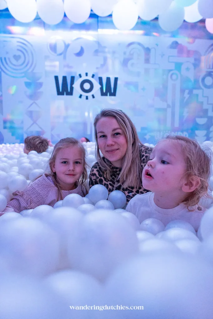 Family playing in the ball pit at WONDR Experience in Amsterdam.