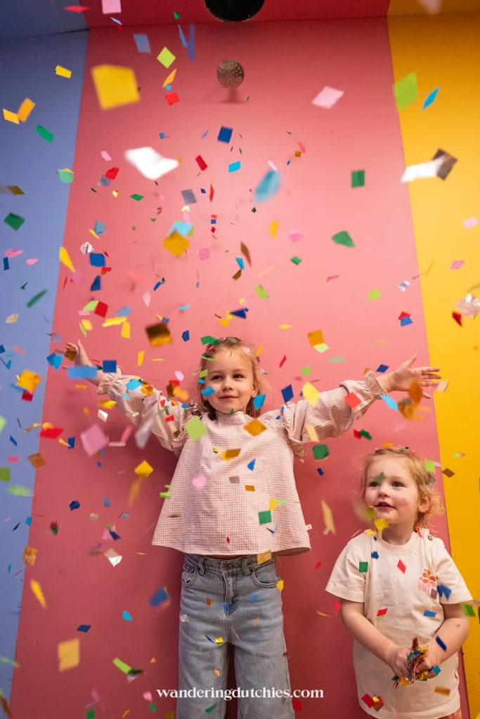 Children playing with confetti at WONDR Experience in Amsterdam.