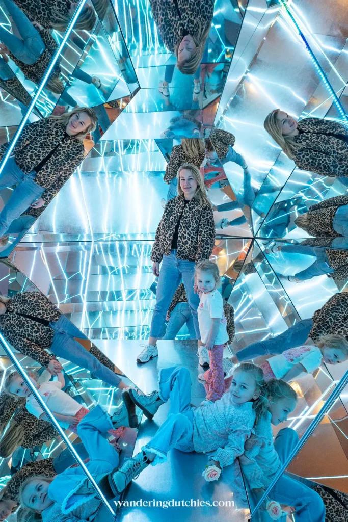 Mother and her children in a mirror room at WONDR Experience in Amsterdam.